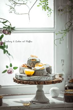 there is a cake with lemons on it and flowers in the window sill