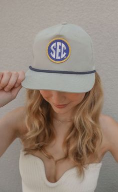 Rep the Southeastern Conference in this trendy trucker hat in a neutral grey hat with a black rope. This roped style trucker will be the perfect gameday (and every other day) accessory. ALL HATS ARE FINAL SALE! Southeastern Conference, Grey Hat, Black Rope, Final Sale, Trucker Hat, Hats, Grey, Black