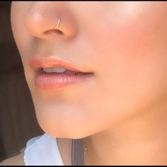 a close up view of a woman's face with her nose piercings on