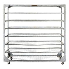 a metal rack with four shelves on each side and two wheels attached to the bottom