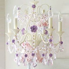 a white chandelier with pink and purple flowers on it