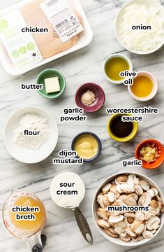 ingredients for chicken broth laid out on a marble counter top, including eggs, mushrooms, flour, butter, garlic, and seasoning