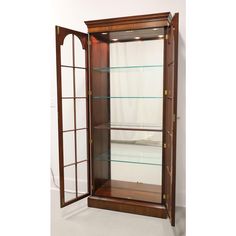 a wooden display case with glass shelves in the front and side doors on both sides