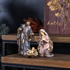 a nativity scene with two figurines and a baby jesus