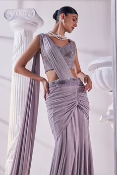 Lilac pre-draped saree crafted from shimmer lycra. Paired with a cutdana and bead embellished corset and cutwork embroidered belt with tassels. - Aza Fashions Fusion Pre-draped Saree With Unstitched Blouse For Diwali, Festive Fusion Pre-draped Saree With Unstitched Blouse, Fitted Pre-draped Saree With Draped Sleeves For Diwali, Evening Sleeveless Pre-draped Saree With Cutdana, Designer Fusion Pre-draped Saree For Diwali, Semi-stitched Draped Party Wear Choli, Party Wear Pre-draped Saree For Reception, Fusion Style Wedding Saree With Unstitched Blouse, Pre-draped Saree With Dupatta For Reception