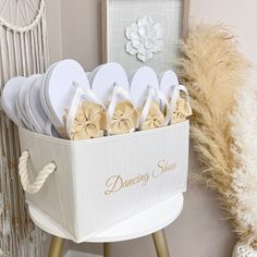 a basket filled with white slippers sitting on top of a table