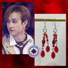 a pair of earrings with red beads hanging from it's earwires, and an image of a young man wearing a white shirt