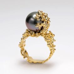 This unique coral pearl ring is part of a collection inspired by the living sculptures of corals. A large top quality round genuine Tahitian pearl is gently held by a coral made of 14k gold. Exotic Tahitian cultured pearls add a dramatic touch of beauty and charm to every jewel. The natural color of these pearls comes from the color of the oyster's black lips. They're naturally dark colored and very durable due to their particularly hard surface. They are some of the most sought-after, expensive Gold Pearl Engagement Ring, Amber Engagement Ring, Rose Gold Black Diamond Ring, Pearl Gold Ring, Tahitian Pearl Ring, Black Pearl Ring, White Gold Sapphire Ring, Yellow Citrine Ring, Citrine Ring Engagement