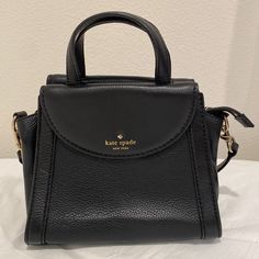 Black Leather Satchel, Great Conditon. Please See Photos For Slight Scuffs And Scratches, Hardly Noticeable. Interior Is In Excellent Shape, No Stains. Zip Top Closure, Two Exterior Magnetic Flap Pockets On Either Side. Removable/Adjustable Strap. Drop Is Approx 21 Inch On Shortest Setting. 9 X 7.75 X 4.5 Inches. Bags Kate Spade, Black Satchel, Black Leather Satchel, Kate Spade Bags, Kate Spade Bag, Leather Satchel, Zip Top, Flap Pocket, Kate Spade