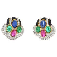 These David Webb earrings are a stunning example of the brand's exquisite craftsmanship and attention to detail. Measuring at about 3cm in length, they are crafted in 18k yellow gold, giving them a luxurious and timeless appeal. The earrings are adorned with a combination of cabochon cut sapphires, green emeralds, and rubies, each carefully selected to complement the others in a stunning display of color. The addition of black enameling and pave set round diamonds 3.00cttw further enhances the o Dragon Bracelet, David Webb, Ruby Earrings, Diamond Star, Antique Earrings, Enamel Jewelry, Exquisite Jewelry, Black Enamel, Artisan Jewelry