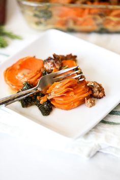 a white plate topped with carrots and meat