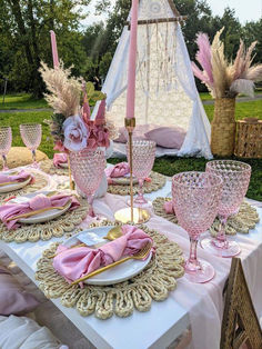 a table set with pink and gold place settings