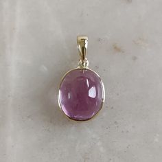 DESCRIPTION: This stunning Pendant is set in 14k Solid Yellow Gold with Natural Kunzite with utmost precision. It is a unique gemstone Pendant for nearly every occasion and is completely hassle-free jewelry. ITEM DETAILS: * CENTER GEM: Kunzite * GEM SIZE: 10X11mm * GEM SHAPE: Oval * Gem weight: 8.30 carats * Gold Purity: 14KT (58.33% approx.) * Gold Weight: 0.54 gram * Total Weight of the Pendant: 2.20 gram The Gold purity is guaranteed and it comes with authentic 14KT gold hallmark. Since my items are handmade, they are absolutely nickel and lead free. CUSTOMIZATION: * Gemstone customization is available and it can be substituted with a gem of your choice. Kindly message me for the same. PACKAGING * The Pendant comes with layers of safe and secure wrapping along with Free handmade jewelry Luxury Yellow Gold Oval Cabochon Gemstones, Exquisite Oval Gemstones With Accents, Luxury Oval Gemstones, Luxury Oval Gemstone Cabochons, Yellow Gold Oval Cabochon Gemstones, Elegant Gold Gemstones With Polished Finish, Elegant Gold Cabochon Gemstones, Oval Luxury Gemstones With Accents, Luxury Gold Oval Cabochon Gemstones