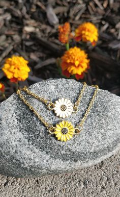 "This bracelet is perfect for anyone! You can choose a yellow sunflower or a white daisy. The metal is a gold color. The flower measures 1/2\" wide. The bracelet has an extender on it so it is adjustable, and it has a heart charm at the end. Perfect for a Mom gift, for a Christmas gift, anniversary, or a birthday. All jewelry items come in a gift box." Gold Bracelet With Birth Flower Design, Gold Bracelets With Flower Shape For Mother's Day, Gold Flower-shaped Bracelets For Mother's Day, Gold Flower-shaped Bracelet For Mother's Day, Gold Bracelet With Birth Flower For Gift, Cute Gold Flower-shaped Jewelry, Personalized Gold Flower Bracelets, Dainty Yellow Bracelet For Gift, Dainty Yellow Bracelet As Gift