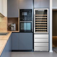 a modern kitchen with stainless steel appliances and wood counter tops