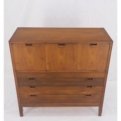 a wooden dresser with three drawers on one side