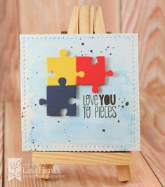 an easel with two pieces of puzzle on it that says i love you to pieces