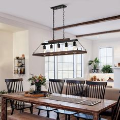 a dining room table with four chairs and a bench