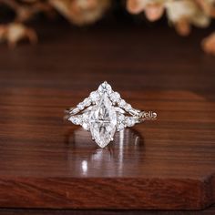 a diamond ring sitting on top of a wooden table