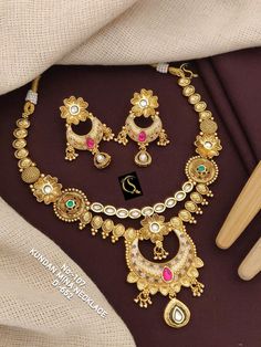 Description :- Gold Necklace, Indian Gold Necklace Set, Indian Choker, Pearl Necklace, Guttapusalu Necklace, Temple Jewelry, Jhumkas, South Indian Jewelry Gift yourself a royal look with this perfectly crafted kundan necklace set from Manalisstudio. Crafted with high quality kundan stones and pearls, it is impressive in design. The green enamel artwork adds perfect texture to the design. Perfect for weddings and festivities, this antique necklace set should be put on with your favorite sari or l Indian Gold Necklace Set, Gold Necklace Set Indian, Indian Gold Necklace, Guttapusalu Necklace, Choker Pearl Necklace, Choker Pearl, Indian Choker, Gold Necklace Indian, Necklace Set Indian