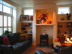 a living room filled with furniture and a fire place