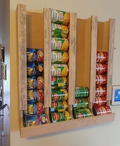 a wooden spice rack filled with canned food