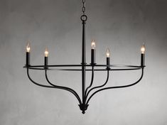 a black chandelier with five candles hanging from it's center and four arms