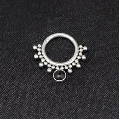 a silver ring with beads on it