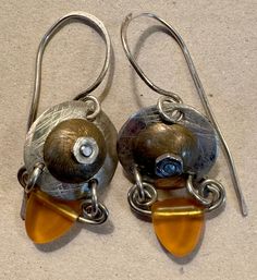 I don't know much about this besides it was my mother's. I am finally going thru her jewelry. The picture is all the info I have! Cadmium-free Dangle Earrings For Anniversary, Anniversary Dangle Earrings Cadmium-free, Vintage Amber Nickel-free Earrings, Vintage Amber Dangle Earrings, Unique Soldered Drop Earrings, Amber Glass, Etsy Earrings Dangle, Artisan Jewelry, Amber