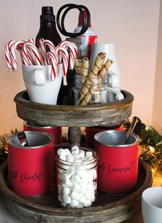 a tray filled with candy canes, hot chocolate and marshmallows