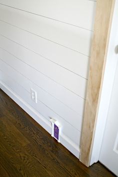 an empty room with wood flooring and white paint on the walls is shown in this image