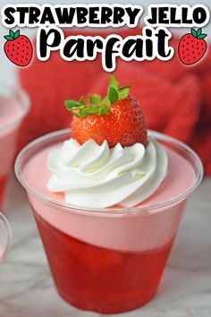 strawberry jello parfait with whipped cream and fresh strawberries in the background