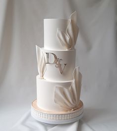 a three tiered wedding cake with white icing