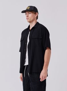 The Crepe Shirt in Black is designed to be your next trans-seasonal wardrobe staple constructed from 100% Cotton crepe. Layer it up over a tee or tank for a more casual look and button it up when the formalities kick in. Classic Collar Double Chest Pockets Oversized Fit Unstructured Camp Shirt For Summer Workwear, Unstructured Summer Camp Shirt For Work, Casual Collared Rayon Shirt, Classic Black Short Sleeve Shirt For Spring, Casual Rayon Collared Shirt, Classic Summer Tops For Streetwear, Casual Button-up Rayon Shirt, Casual Rayon Button-up Shirt, Relaxed Fit Button-up Short Sleeve Shirt For Streetwear