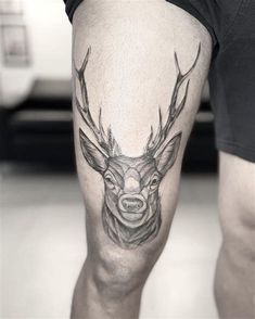 a man with a deer tattoo on his leg