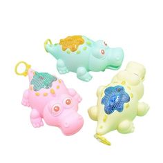 three toy animals with hats on their heads and one has a keychain in the shape of a hippopotamus