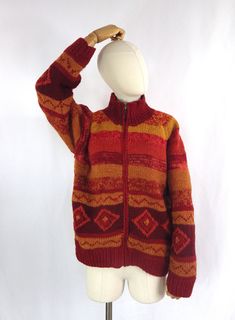 A vibrant hand knitted, lined, chunky wool cardigan/jacket.  Size: 14 UK M medium  Bust: 42"  Pit to pit: 21" Pit to cuff: 17" Collar to cuff: 26.5" Length: 23.5" She is in lovely condition and comes from a smoke free home.  Please do contact us for more information or if you would like to combine postage on multiple items. Bohemian Orange Winter Outerwear, Orange Knitted Outerwear For Winter, Winter Orange Knitted Outerwear, Winter Knitted Orange Outerwear, Orange Wool Winter Outerwear, Retro Orange Cardigan For Winter, Retro Orange Winter Cardigan, Chunky Knit Vest, Boho Orange