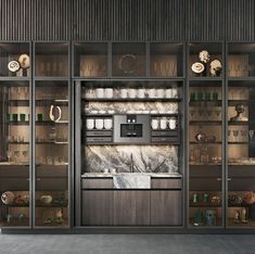 an open kitchen with marble counter tops and cabinets