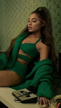 a woman with long hair sitting on a table