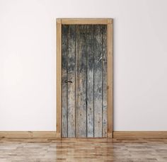 an old wooden door in a white room