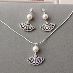 White Sterling Silver Jewelry Sets With Elegant Design, Pearl White Crystal Jewelry With Matching Earrings, Classic Sterling Silver Jewelry Sets For Wedding, White Pendant Earrings For Wedding, Elegant Silver Dangle Jewelry Sets, Classic Silver Jewelry Sets With Pearl Drop, White Pendant Jewelry Set For Wedding, Silver Crystal Jewelry Sets With Matching Earrings, Wedding Sterling Silver Necklace With Matching Earrings