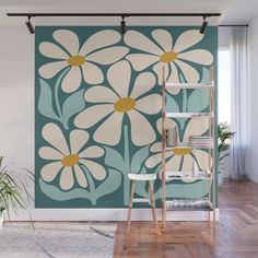 a wall mural with daisies in blue and white on a wooden floor next to a ladder