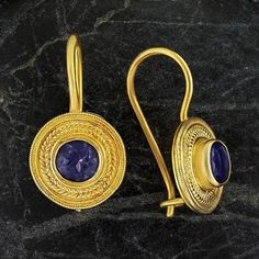 Handcrafted of a tiny disc of filigree thread, this classic Greek design highlights the beauty of a single amethysts are subtle yet undeniably brilliant. 24k gold over sterling silver; hinged backs. Size: 7/8 Inches. Gold Round Pendant Earrings For Formal Events, Gold Round Pendant Earrings For Formal Occasions, Purple Earrings With Intricate Design As Gift, Purple Earrings With Intricate Design For Gift, Silver Round Byzantine Earrings, Gold Plated Round Filigree Jewelry, Byzantine Style Round Gemstone Jewelry, Gold Amethyst Jewelry With Filigree Detail, Gold Amethyst Jewelry With Filigree