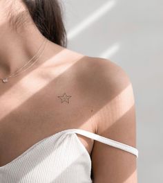 a woman with a star tattoo on her shoulder