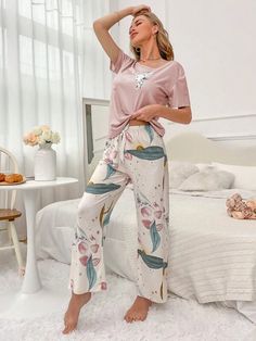 Elevate your comfort with our Floral Print Tee And Pants Pajama Set. Experience the joy of our exquisite cartoon and floral patterns, beautifully complemented by a delicate knot detail. Designed for relaxation, this 2-piece set features a round neck, short sleeves, and a regular fit. Crafted from high-quality knitted fabric with medium stretch, it offers both style and ease. Specifications: Pattern Type: Cartoon, Floral Type: Pant Sets Neckline: Round Neck Details: Knot Sleeve Length: Short Slee Casual Printed Sleep Sets, Casual Floral Print Sets For Sleepover, Casual Floral Print Sleepover Sets, Pink Floral Print Lounging Set, Casual Pink Floral Print Sleepwear, Casual Floral Print Lounging Sets, Floral Print Sleepwear For Pajama Party, Floral Print Sleepwear Long Pants For Loungewear, Pink Floral Print Loungewear Sets