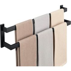 three towels hanging on a towel rack with two black brackets and one beige towel holder