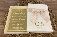 the wedding program is on display in a basket next to it's box and ribbon