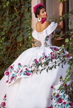 Dance the night away in this floral charro off the shoulder ball gown with A-line split front skirt by Ragazza Fashion M41-141. This beautiful long off the shoulder dress features an illusion V-neck bodice adorned with sequined and beaded floral appliques, short sleeves, open lace-up corset back, and a floor length A-line skirt with a sweep train. Floral Charro Off Shoulder Quinceanera Dress by Ragazza M41-141 Designer: Jazmín Collection by Ragazza Fashion 2023 Style Number: M41-141 Colors: Ivor Charro Dress, Quinceanera Dresses Mexican, Split Front Skirt, Vestido Charro, Xv Dresses, Mexican Quinceanera, Quinceanera Themes Dresses, Mexican Quinceanera Dresses, Charro Quinceanera Dresses