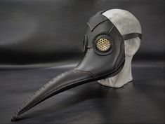 a leather mask with a metal eye patch on it