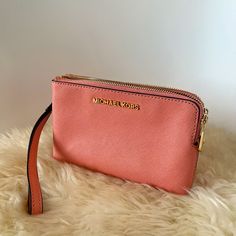 Salmon Colored Wristlet. Never Used, No Blemishes. Trendy Wristlet With Zipper Pouch, Everyday Michael Kors Rectangular Clutch, Michael Kors Rectangular Clutch For Travel, Michael Kors Rectangular Everyday Clutch, Chic Pink Wristlet For Travel, Clutch Wristlet With Zipper Closure, Michael Kors Clutch With Zipper Closure, Michael Kors Clutch With Zipper For Everyday Use, Zipper Pouch Wristlet